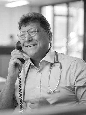 A doctor talks to a patient over the phone. 