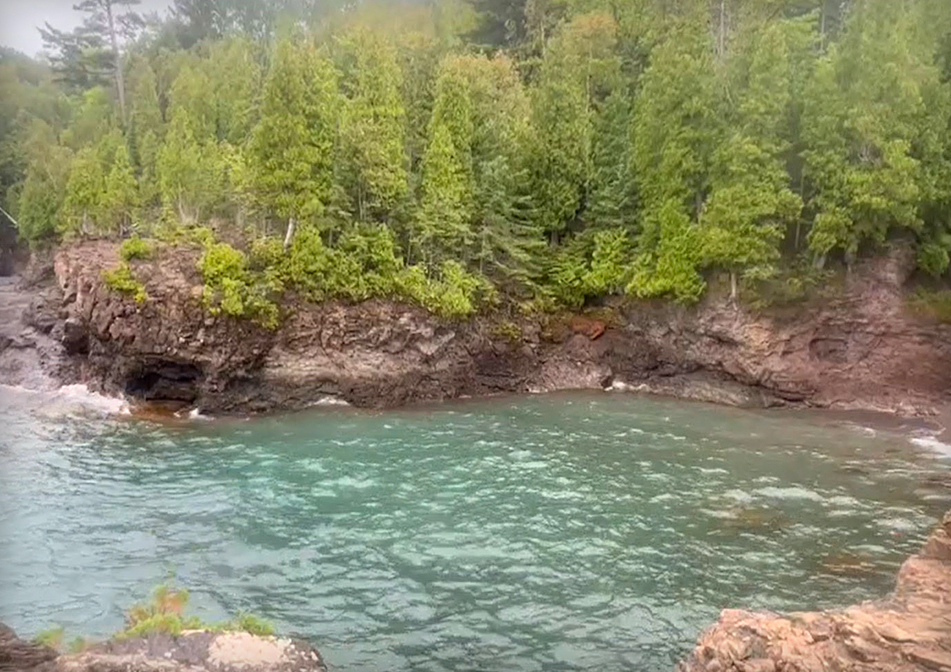 A cove surrounded by green trees. 