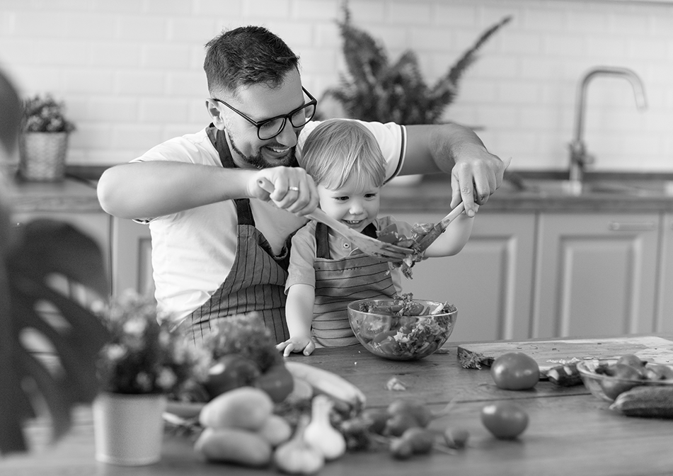 Man and child making a salad