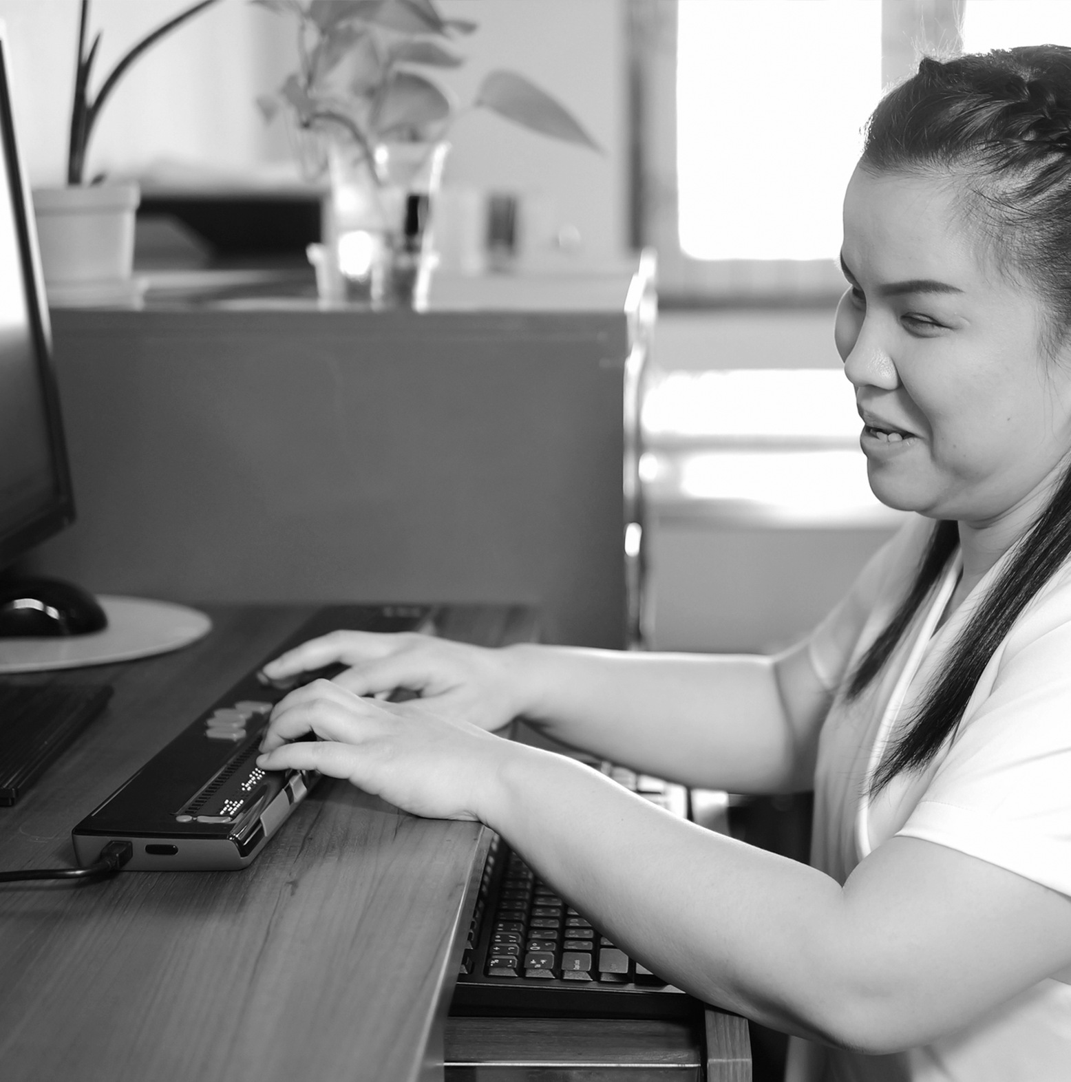 A woman uses assisted to technology to work on a computer