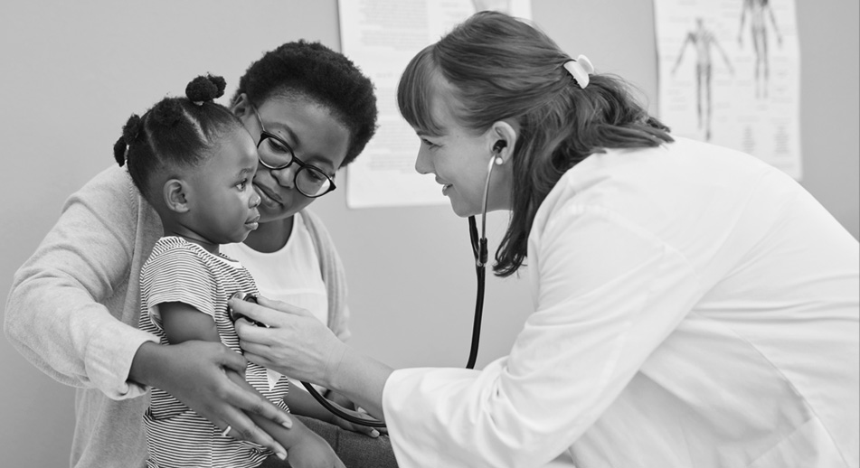 BCBSM provider listening to a young patient's heartbeat