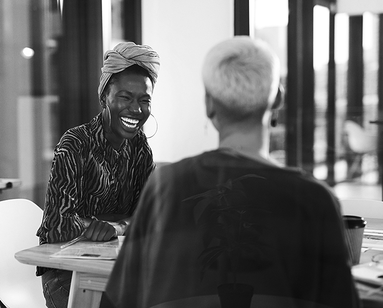 Two happy women look over their plans together