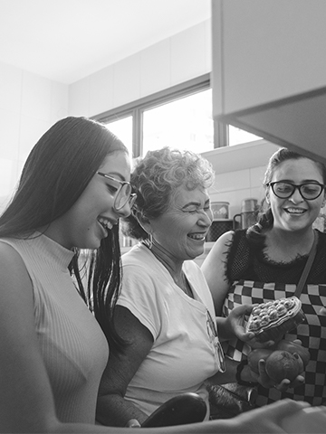 A group of women laugh and support each other. 
