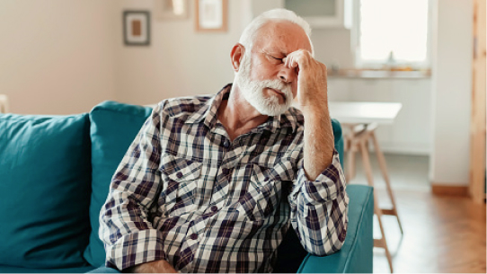 A man sits with a headache