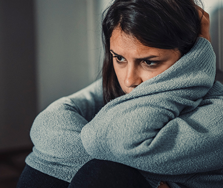  A young woman sits deep in thought looking sad