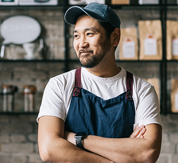 A smiling man in a work apron