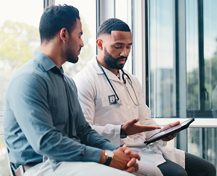 A man talks with a doctor