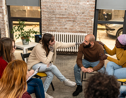 People sitting in a circle at a support group