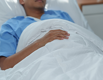 A man lying in a hospital bed