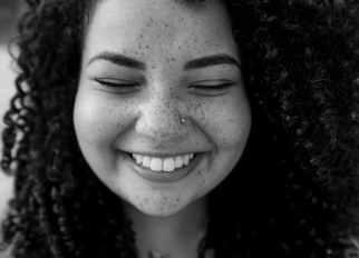 A woman closes her eyes and smiles