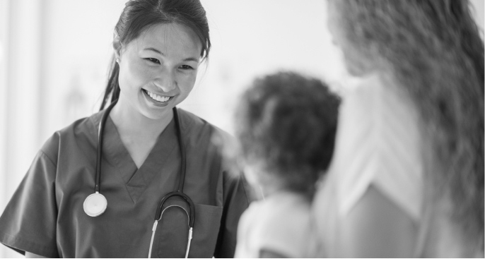 Photo of a female physician smiling at a patient