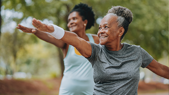 Two women exercise together.