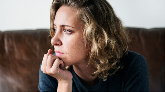 A woman sits while deep in thought