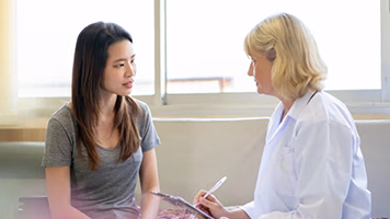 A woman speaks to her doctor
