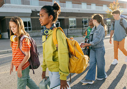 A group of students walking out of a school