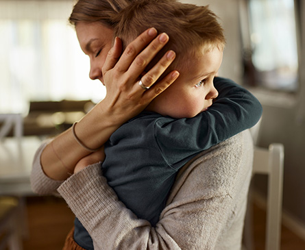 A mother hugging her son