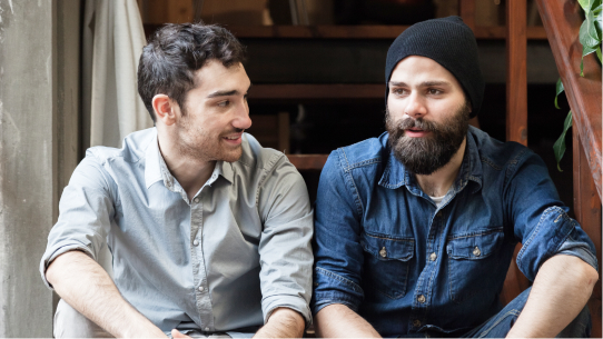 Two men sit and discuss their mental health struggles