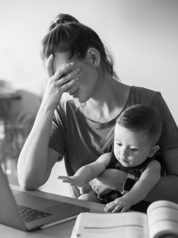 A mother cries while holding her baby