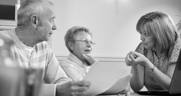 Two seniors discuss mental health with a professional