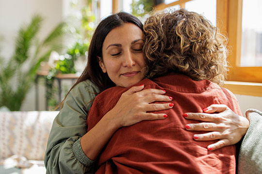 Two women hugging