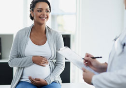 A photo of a pregnant person at the doctor