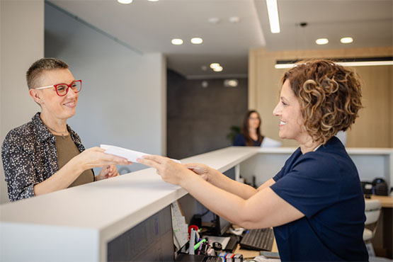 A patient talking with medical care office administrator