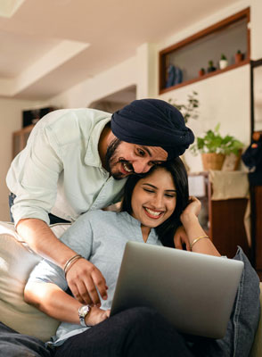 A man and a woman looking at a laptop