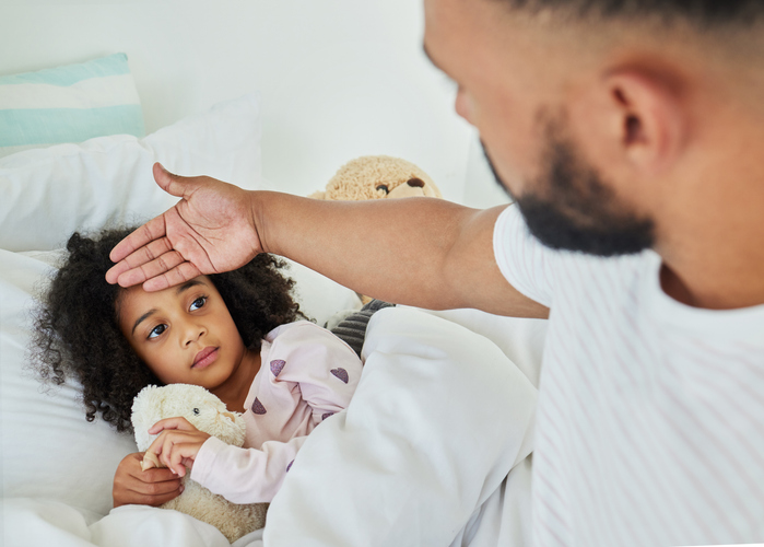 a father takes care of his sick daughter 