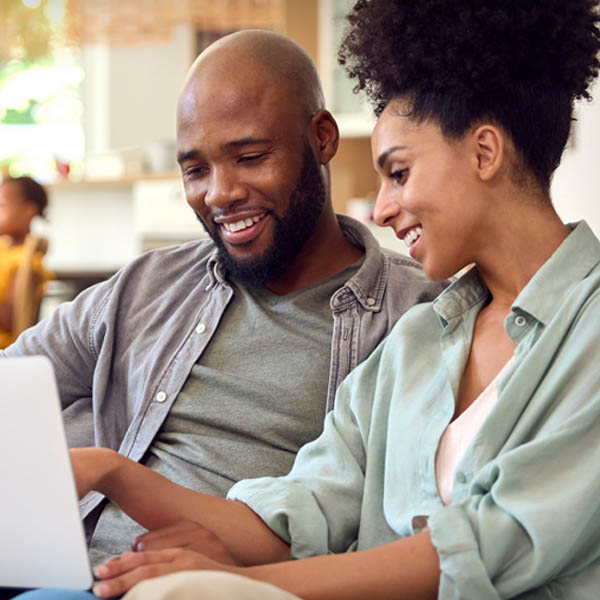 two people looking at laptop and talking
