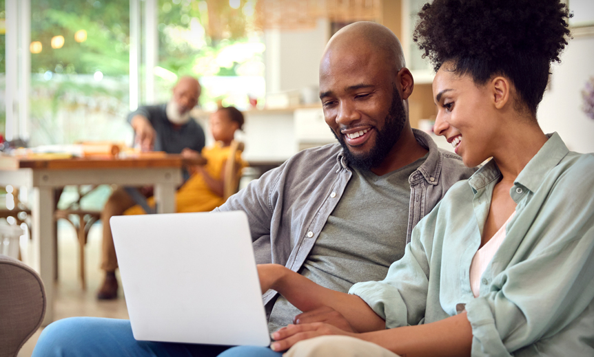 two people looking at laptop and talking