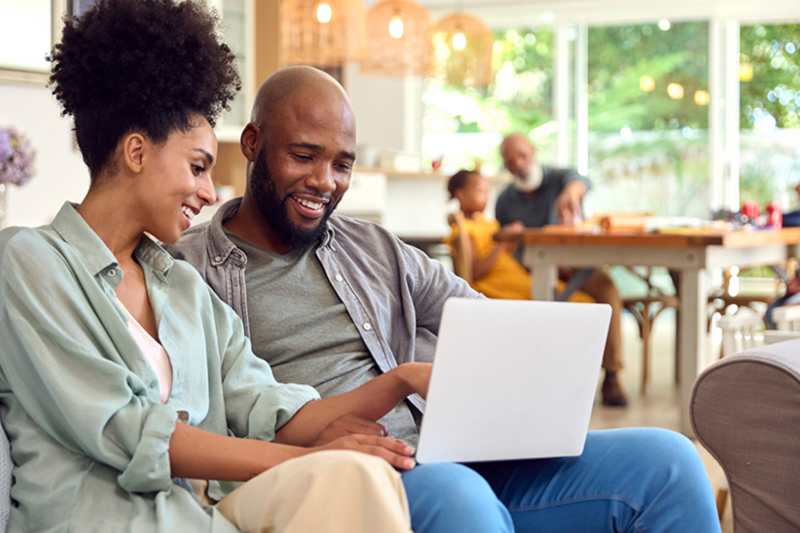 Couple sitting looking at a laptop