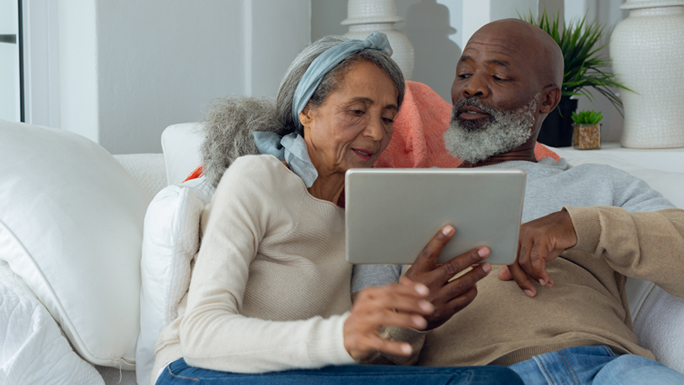 Two people look at a tablet device together