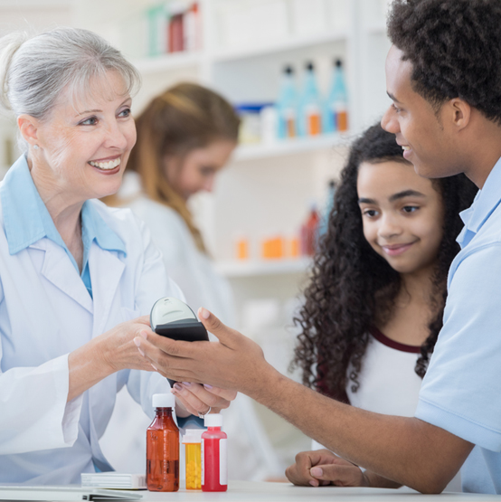 A pharmacist scans the mobile device of a customer