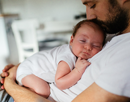 A father holds his baby.