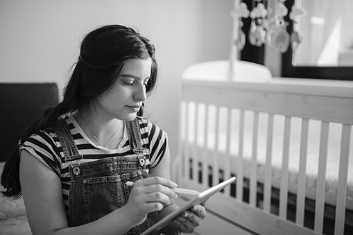 A young woman makes a list.