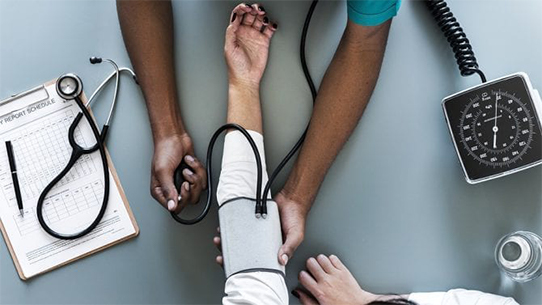 A nurse takes a patient's blood pressure.