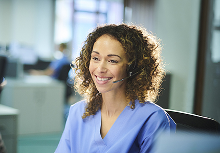A nurse talks with a patient over the phone.