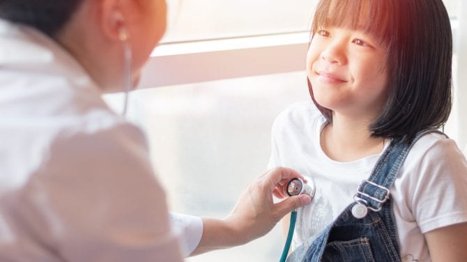 A pediatrician gives a little girl a check-up.