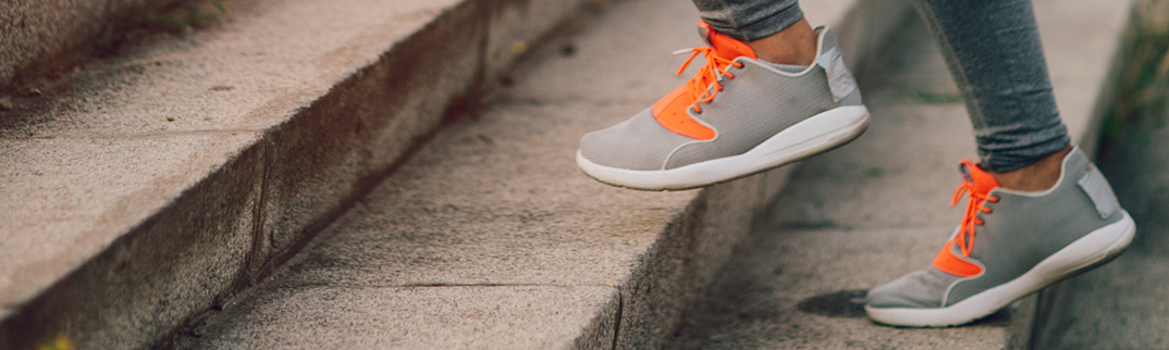 A close-up image of someone's feet climbing some steps.