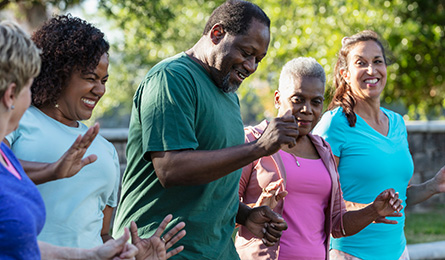 A group of people smile as they work out.