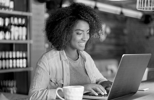 A woman reads about her plan online.