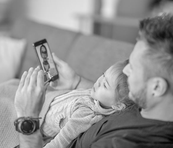 parent and child looking at phone