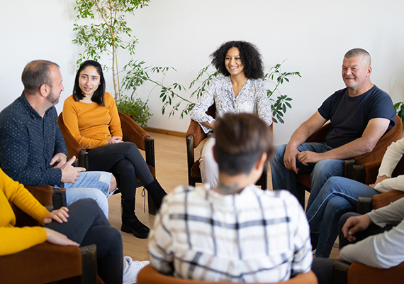 A group of individuals sit in a meeting together