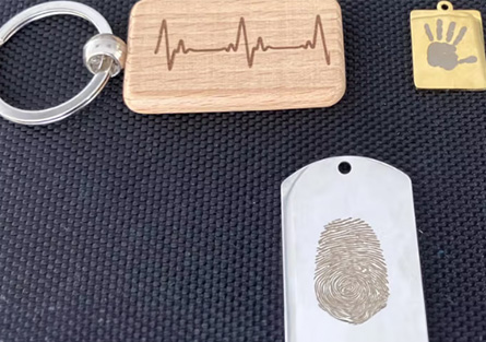 Memorial keepsakes featuring a heartbeat design, fingerprint and child's handprint.