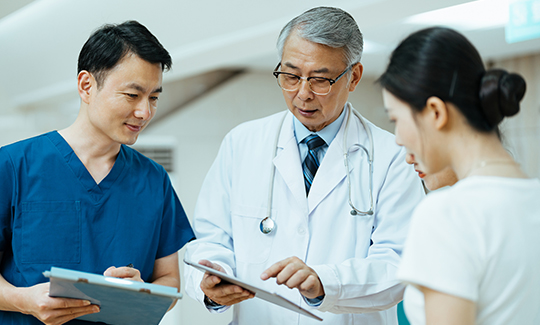 Medical professionals review a chart together.