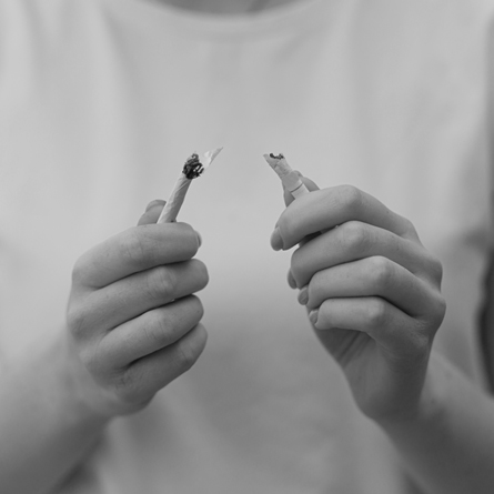 A cigarette being broken in half