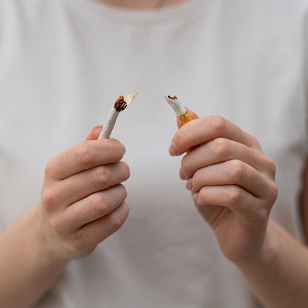 A cigarette being broken in half