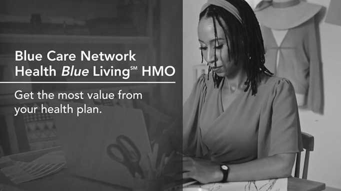Cover image for Healthy Blue Living plan highlights video featuring a woman sitting at a desk typing on a laptop