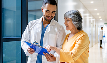 A doctor shows some medical documents to another doctor