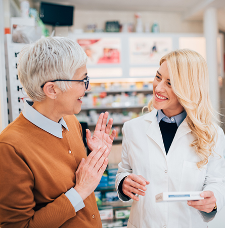 Medicare pharmacist helping woman with her prescription. 